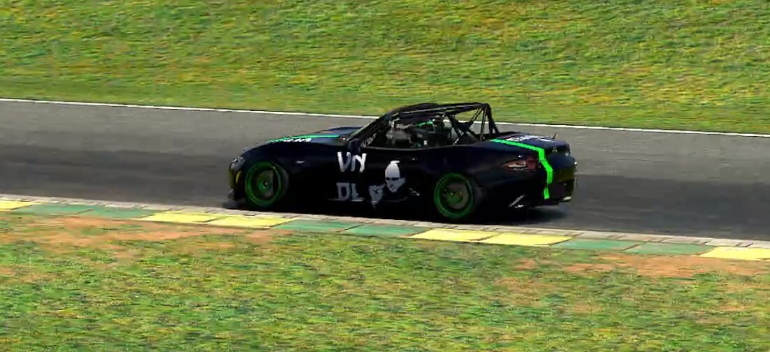 MX-5 Cup car in a black and green sponsor livery, side view